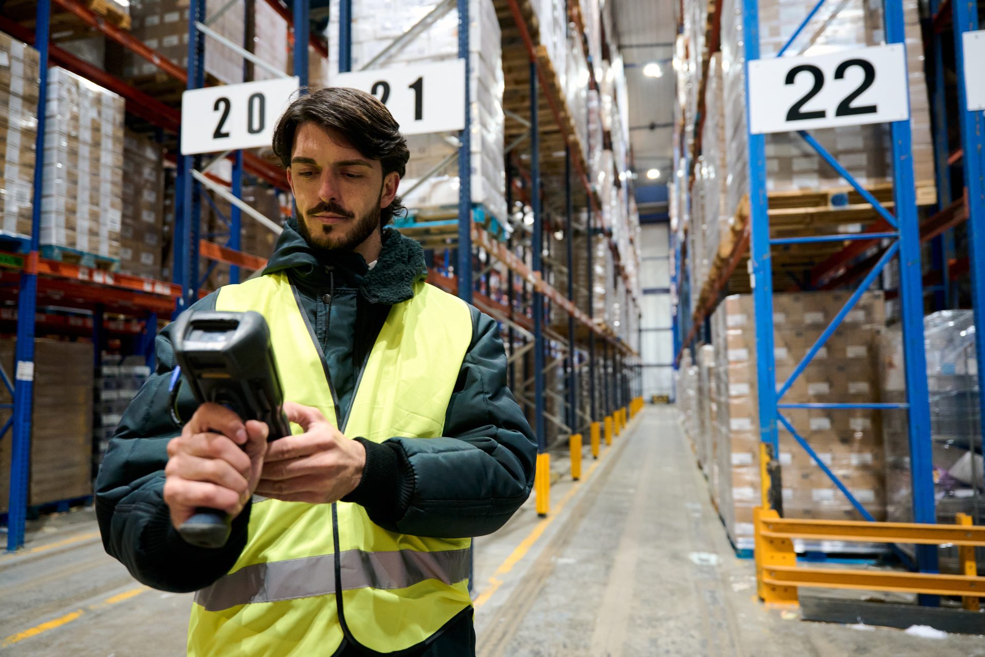 An operator recording a decision on a rugged RF handheld at a dock door